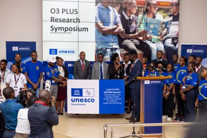 Minister of Education and Vice Chancellor poses for a photo with students 