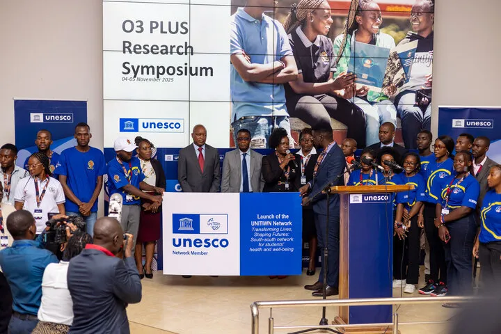 Minister of Education and Vice Chancellor poses for a photo with students 